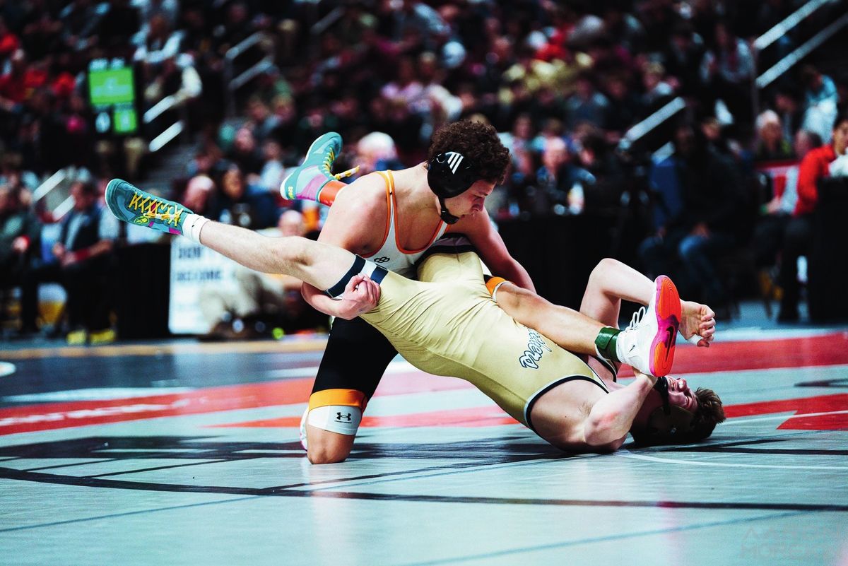 Gabe Ballard drives through his opponent's legs toward the mat
