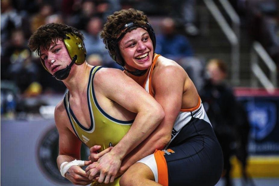 Gabe Ballard smiles while controlling his opponent from behind
