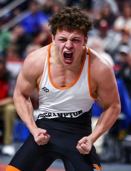 Gabe Ballard roars and flexes after a win at the PIAA Championships