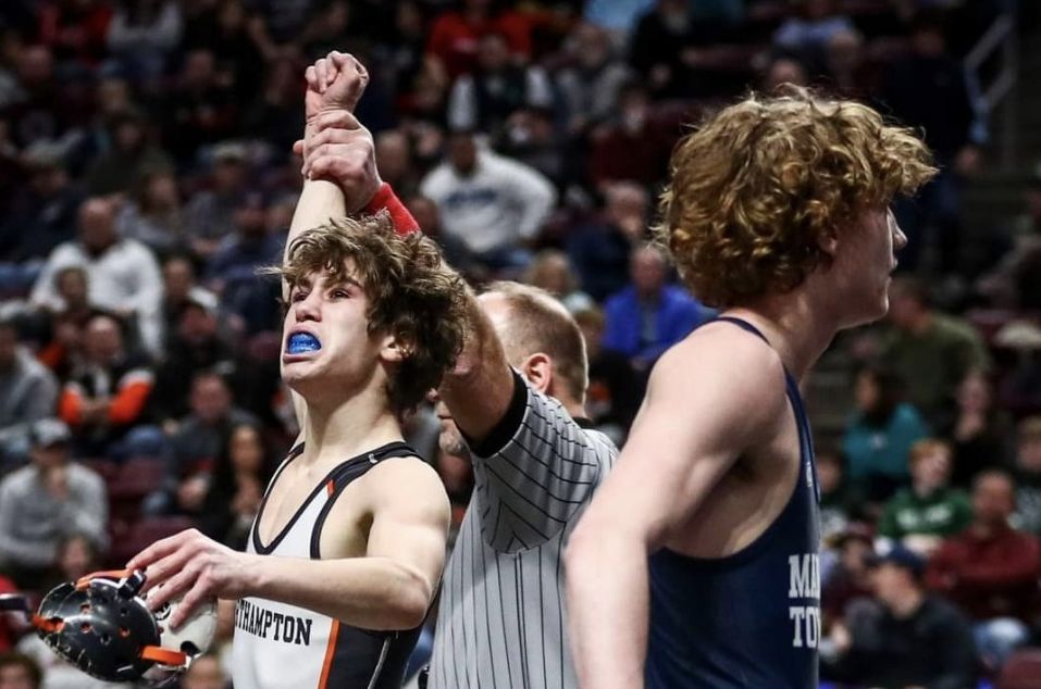 Carson Wagner has his hand raised at the state tournament