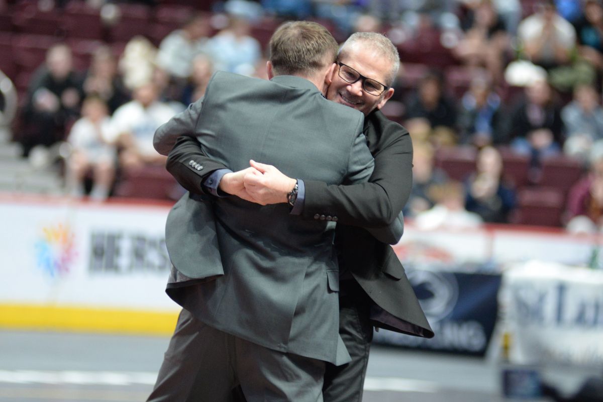 Two Northampton coaches embrace on the arena floor at the Giant Center