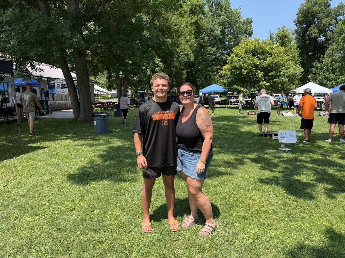 Gabe Ballard smiles with a supporter on the tournament grounds