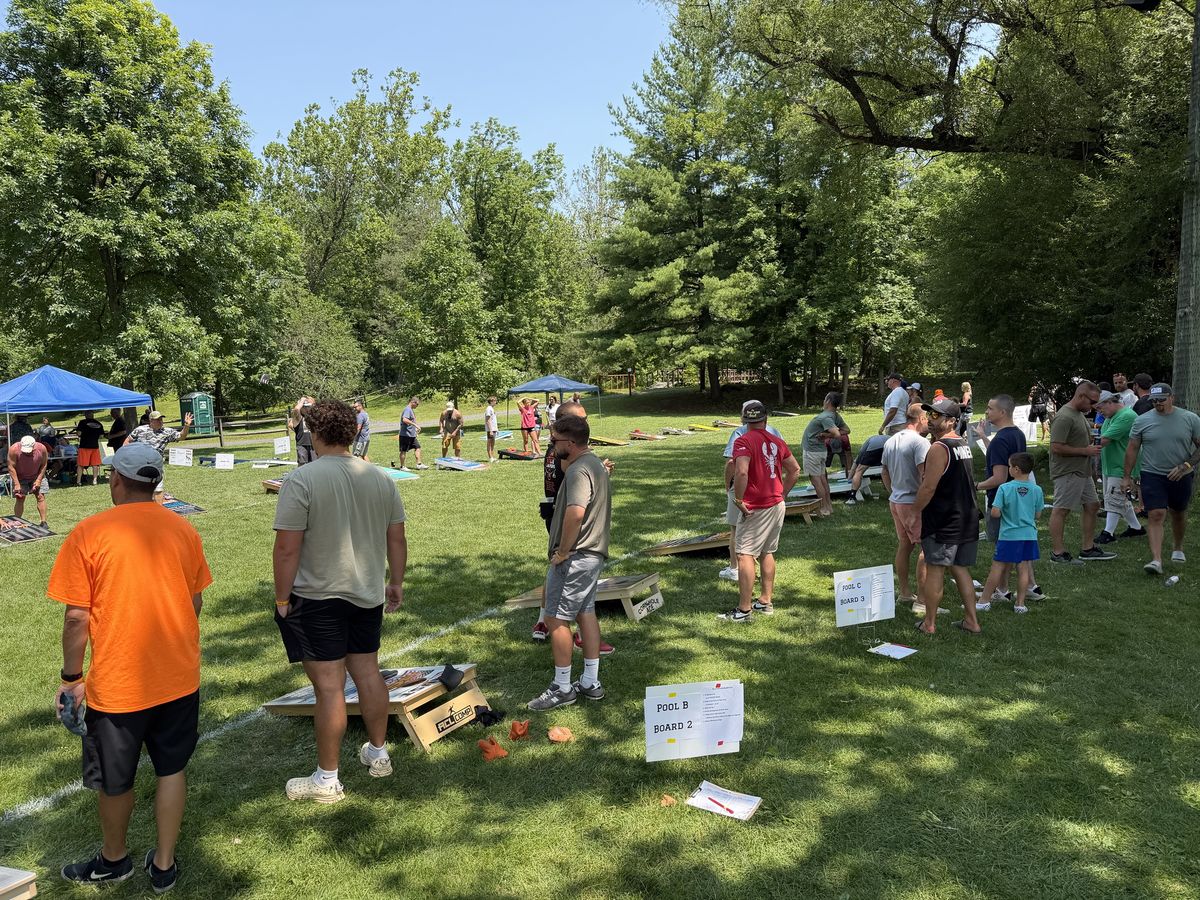 Players gather around boards marked Pool B and Pool C during pool play