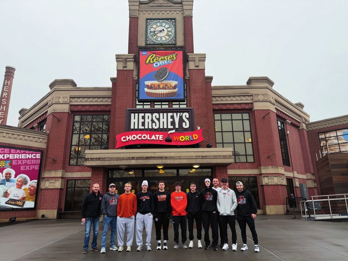 Northampton wrestlers and coaches stand in front of Hershey's Chocolate World