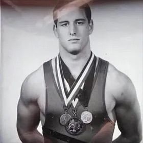 Christian Luciano wearing his state championship medals