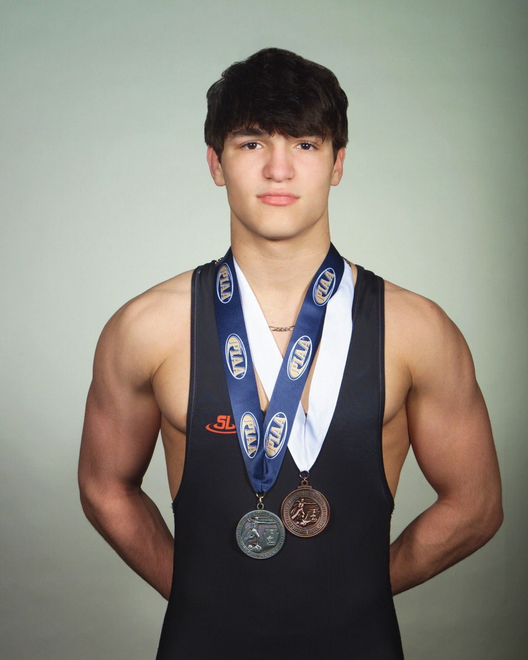 Austin Noe in his Northampton singlet wearing his postseason medals