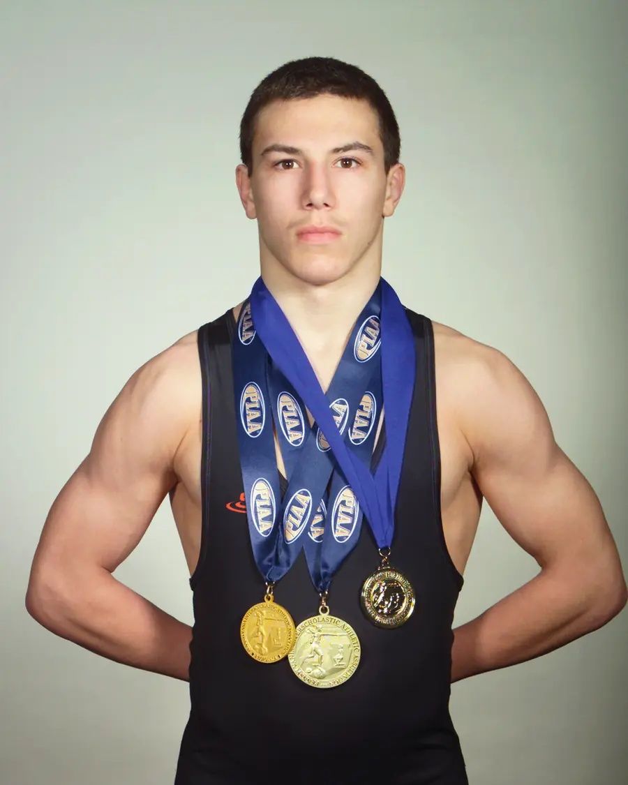 Trey Wagner in his Northampton singlet wearing his 2024 state championship medals