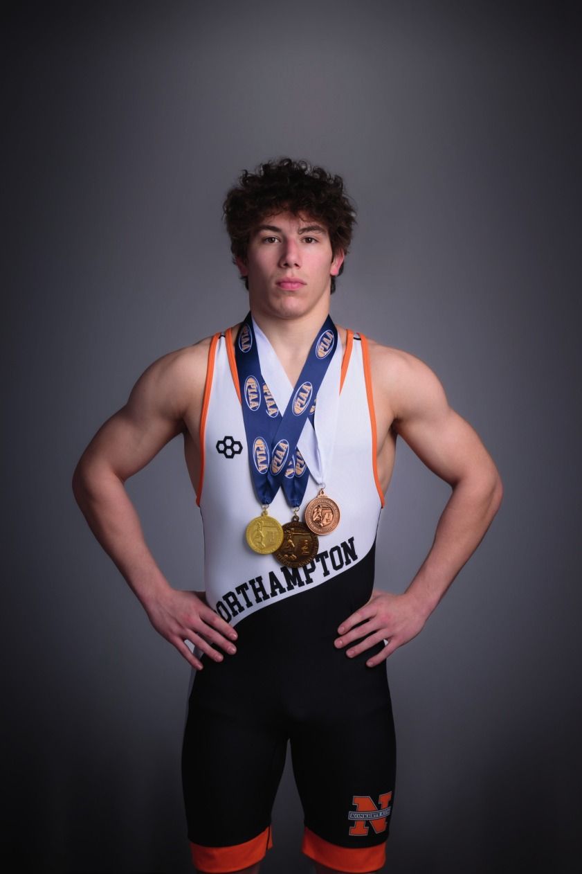 Trey Wagner in his Northampton singlet wearing his postseason medals