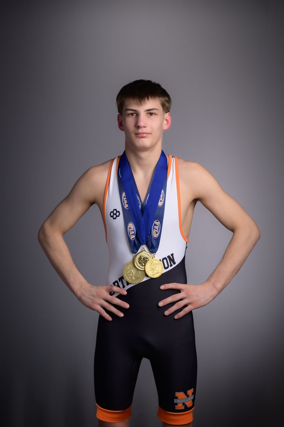 Brayden Wenrich in his Northampton singlet wearing his postseason medals