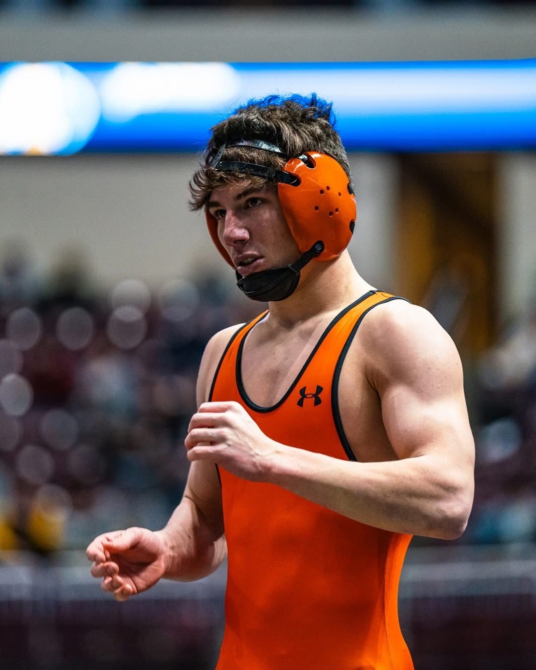A Northampton wrestler in orange headgear between periods