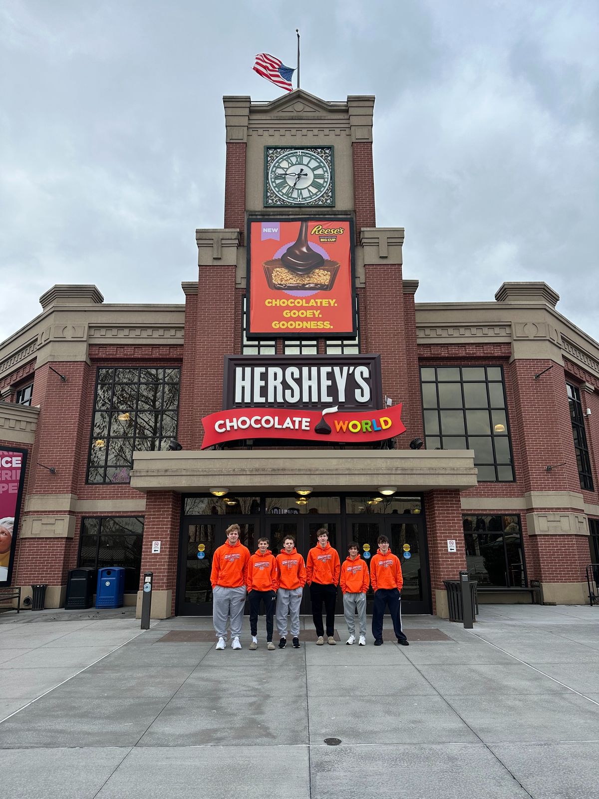 The team in orange in front of Hershey’s Chocolate World