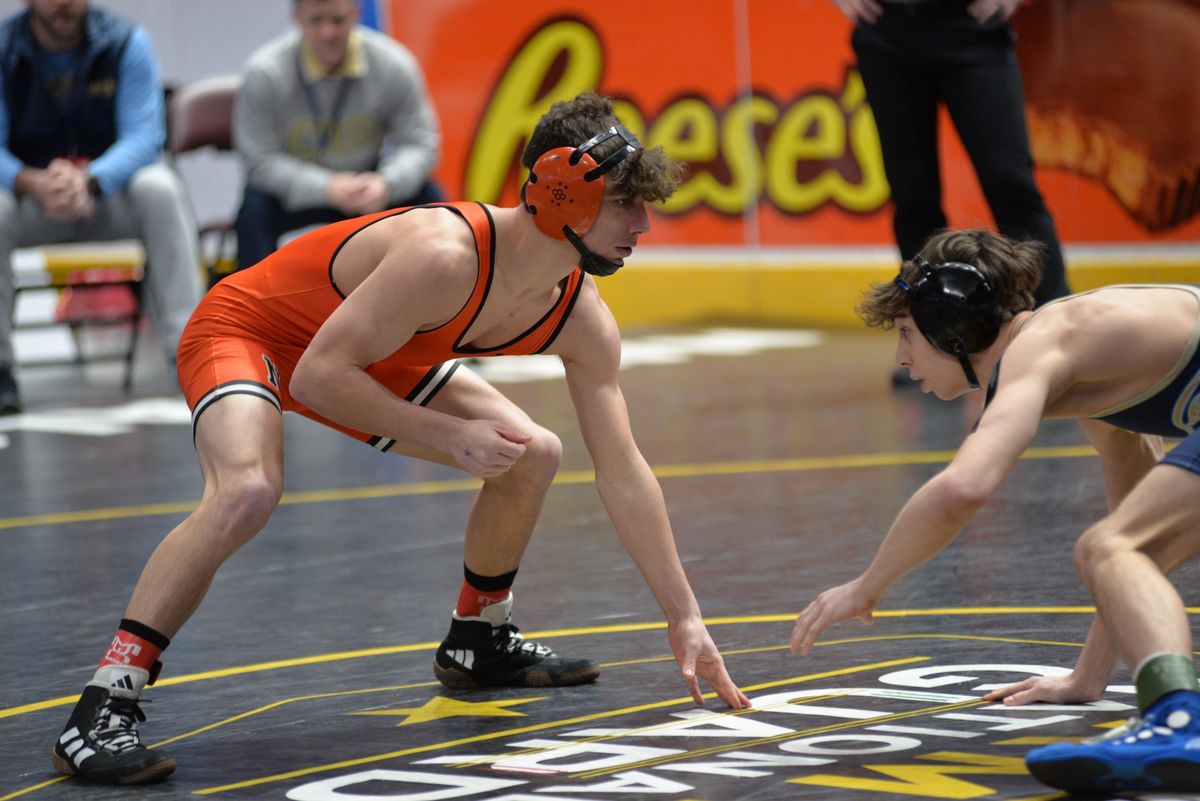 A Northampton wrestler in his stance under the Reese’s banner