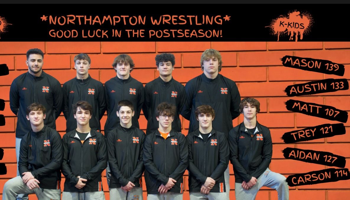 The 2022–23 postseason lineup in front of a good-luck banner listing each wrestler and weight
