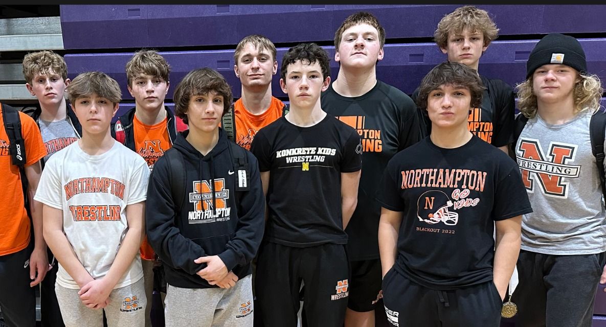 Northampton wrestlers pose together in team shirts