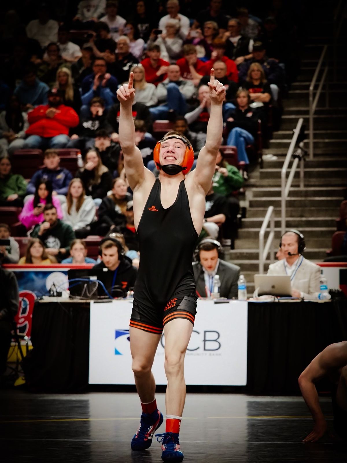 Trey Wagner grins and points both fingers skyward after a win at the PIAA Championships