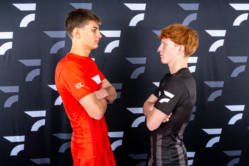 Brayden Wenrich and his opponent face off with arms crossed in front of a FloWrestling backdrop
